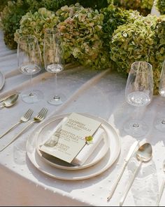 the table is set with silverware and place settings for an elegant dinner or reception