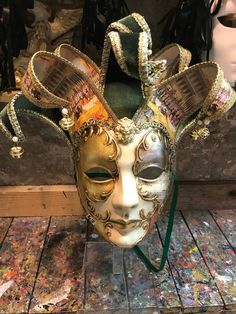 Original hand-painted Venetian mask embellished with gold leaf, stucco decoration, acrylic colors and precious fabrics. Ideal mask for carnival parties. -Made in Italy hypoallergenic and anatoxic material/resin -Dimensions/40x37 unisex -History of the mask/the Jester or joker is a mask that appears in Venice in 1970, the year in which the Venetian Carnival returns to its ancient splendors after being interrupted during the Napoleonic (1700') and Austro-Hungarian (1800') domination. Anciently a s Fantasy Carnival Mask For Festivals, Fantasy Masks For Carnival And Festivals, Fantasy Theater Mask For Mardi Gras, Artistic Masks For Festivals And Costume Parties, Artistic Masks And Prosthetics For Mardi Gras Carnival, Artistic Masks For Costume Party And Festivals, Traditional Theater Masks And Prosthetics For Festivals, Fantasy Masks And Prosthetics For Mardi Gras Theater, Traditional Theater Masks For Festivals