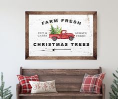 a red truck with a christmas tree on the back sits in front of a white wall