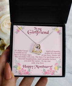 a gift box with a necklace in it and a card inside that says, to my girlfriend