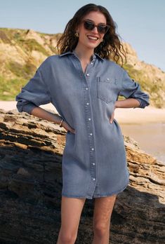 Meet the most comfortable mini you've ever worn! We love the chambray tencel fabric plus the collared, button front design and flattering curved hem for a casual, everyday look. Relaxed fit Chambray Tencel: 100% Tencel Collared Long sleeve Mini length Curved hemline Button front Chest pocket Midweight Heavy soft wash Machine Wash Cold, Gentle Cycle, Hang to Dry Casual Button-up Shirt Dress For Day Out, Summer Chambray Button-up Shirt Dress, Casual Solid Shirt Dress For Daywear, Casual Button-up Shirt Dress With Rolled Sleeves, Casual Dress With Relaxed Fit And Spread Collar, Collared Medium Wash Shirt Dress For Work, Casual Dress With Spread Collar And Buttons, Casual Dress With Buttons And Spread Collar, Casual Solid Shirt Dress With Button Closure