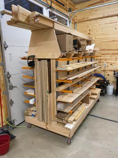 a large wooden shelf in a garage with lots of shelves on the wall and floor