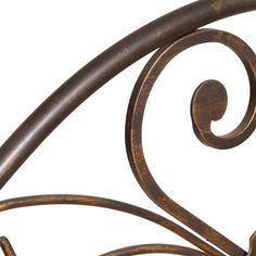 an iron bed frame with curved designs on it