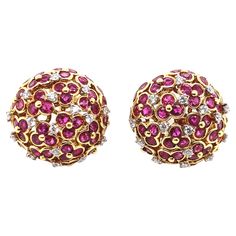 Signed "Jean Vitau," this set of earrings feature an 18k yellow gold surrounded by 10 carat round-cut ruby reds and 1 carat round-cut white diamonds. Together, they weigh 32.7 grams with a length and width of 2.5 cm. Luxury Red Brilliant Cut Earrings, Ruby Brilliant Cut Fine Jewelry Earrings, Ruby Round Cut Fine Jewelry Earrings, Exquisite Round Ruby Earrings, Yellow Gold Ruby Earrings With Brilliant Cut, Yellow Gold Ruby Earrings With Diamond Accents, Luxury Ruby Earrings With Rose Cut Diamonds, Red Ruby Round Diamond Earrings, Flower Tops