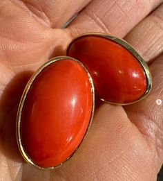 --Stone(s):-- (2) Natural Genuine Corals - Oval Cabochon Cut - Bezel Set -  Reddish Orange Color - 28.94ctw (exact, certified) ** See Certification Details Below for Complete Info ** Material: Solid 18k Yellow Gold Weight: 11.58 Grams Backing: Posts w/ Omega Closures (Pierced ears are required.) Length: 23.5mm (0.92") Width: 15.4mm (0.60") Thickness: 8.9mm (at the coral) projection off the ear Condition: Vintage stones. New earrings. Comes with the original GIA certification for both of the cora Luxury Oval Cabochon Gemstone Earrings, Elegant Red Cabochon Gemstones, Luxury High Luster Oval Earrings, Luxury Oval Cabochon Earrings For Anniversary, Oval Yellow Gold Cabochons For Formal Events, Luxury Oval Gemstone Earrings, Elegant Red Polished Gemstones, Luxury Oval Earrings With Polished Finish, Formal Clip-on Earrings With Oval Cabochon