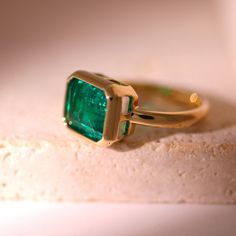 🖐Handmade item ✨Materials: Yellow gold, White gold, Rose gold, Platinum 💎Gemstone: Emerald 🤍Gem Color: Green 💍Band Color: Yellow gold 👑Style: Mid-century 🎨Can be personalized 🎁Gift wrapping available ● 𝐃𝐢𝐚𝐦𝐨𝐧𝐝 𝐃𝐞𝐭𝐚𝐢𝐥𝐬 → Shape: Asscher → Carat: approx 4.0 CT → Color: Green → Clarity: VS1 → Size: 11*9mm → Ring width: 2.5mm → Ring thickness: 2mm 𝗞𝗲𝘆 𝗙𝗲𝗮𝘁𝘂𝗿𝗲𝘀: Fiorese 14K Green Emerald Set Engagement Ring defines the balance of luxury and sophistication with its unique and elegant design. The center of this ring is a bright and magnificent green emerald, reflecting the vitality of nature and the novelty of spring. The selected emerald, with its dark green color, embodies the essence of the growth of all things and is paired with clear-cutting technology to ensur Luxury Yellow Gold Emerald Ring With Tension Setting, Chunky Emerald Ring, Luxury Gold Gemstones For Wedding, Luxury Emerald Rings With Accent Stones, Luxury Emerald Gemstones In Yellow Gold, Luxury Yellow Gold Emerald Gemstones, Yellow Gold Emerald Jewelry With Round Band, Promise Emerald Birthstone Ring In Yellow Gold, Yellow Gold Emerald Birthstone Ring For Promise