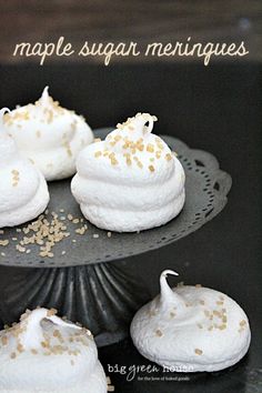 four small desserts with white frosting and gold sprinkles on top