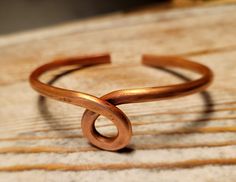 a gold ring sitting on top of a wooden table