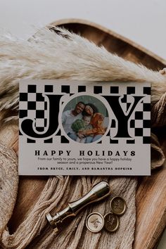 a holiday card with an image of two people and the words, joy happy holidays