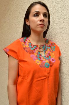 Blouse multicolored handmade by Mexican artisans. . It is important to mention that absolutely all the process is done by hand, so the size, shape and color can varybetween pieces. . Measurements:↕ 26 in↔ 20 6/7 in Artisan Multicolor Cotton Top, Traditional Handmade Multicolor Tops, Traditional Multicolor Handmade Tops, Orange Embroidered Cotton Blouse, Traditional Multicolor Cotton Embroidered Top, Orange Cotton Blouse With Floral Embroidery, Multicolor Embroidered Cotton Top For Festivals, Multicolor Cotton Embroidered Top For Festivals, Multicolor Folk Blouse With Embroidered Neckline