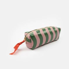 Ideal as a large pencil case or a small cosmetics bags to keep you make up safe and secure, this case is made from leather look PU and comes in our new pink and green wave stripe design. Leather look PU Ideal as a pencil case or cosmetics bag Size: H 50 x L 200 x D 75mm About the designer: Caroline Gardner is best known as one of the UK's leading and most prolific accessory, gift and stationery designers. Her distinctive designs now stretch across various product categories, including paper, acc Portable Green Pencil Shaped Pencil Case, Portable Green Pencil-shaped Pencil Case, Pink Pencil Case With Pen Holders, Green Rectangular Pencil Case With Pen Slots, Green Rectangular Travel Pencil Case, Trendy Green Pencil Case Pouch, Trendy Green Pouch Pencil Case, Green Portable Rectangular Pencil Case, Pink Rectangular Pouch With Pen Holders