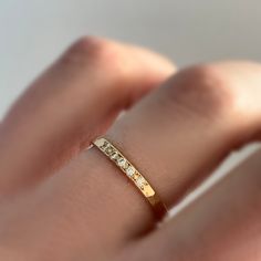 This narrow hammered band set with moissanites could be worn as a stacking ring or wedding band. Choose a color of gold, a number of moissanites, and a finish to customize your ring. Moissanite is a diamond alternative which is lab created. It's more brilliant and nearly as hard as diamond, but without the human and environmental impacts associated with mined stones. The band is hammered and the stones are bead set by hand. DETAILS - band is 2 mm wide and 1.7 mm thick - 1.5 mm moissanites - comf Elegant Hammered Diamond Rings, Minimalist Bands With Single Cut Diamonds For Anniversary, Minimalist Anniversary Bands With Single Cut Diamonds, Hammered Rose Gold Stackable Rings For Wedding, Wedding Stackable Hammered Rose Gold Rings, Wedding Hammered Rose Gold Stackable Rings, Anniversary Rose Gold Hammered Stackable Rings, Hammered Diamond Promise Ring, Rose Gold Hammered Wedding Rings