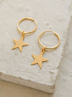 Stay on trend with these minimalistic hoop earrings! These gold filled hoops measure 16mm with a 15mm star dangling from the bottom. Tarnish resistant. Choose from gold-filled hoops or sterling silver. Everyday Gold Star-shaped Hoop Earrings, Star-shaped Hoop Earrings For Everyday, Minimalist Gold Hoop Earrings With Star Charm, Minimalist Star-shaped Hoop Earrings For Pierced Ears, Everyday Small Hoop Earrings With Star Charm, Trendy Hoop Earrings With Star Charm, Minimalist Hoop Huggie Earrings With Star Charm, Minimalist Star Shaped Hoop Earrings, Minimalist Star-shaped Hoop Earrings