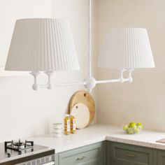 two lamps hanging over a kitchen counter top