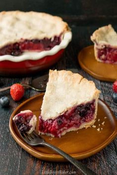 homemade mixed berry pie on a plate with a fork