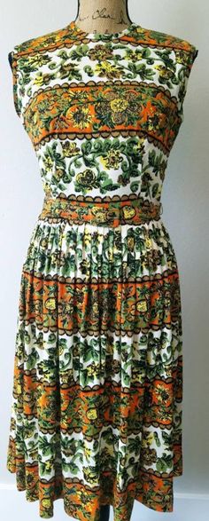 "What a unique printed dress from the 1950s by Style - Aire. -1950s / Early 1960s -Floral multi colored print / Orange, Green, White, Yellow, Brown and Black -Sleeveless -Rayon fabric / Belted -Gathered at the waist / Pleated skirt -Not lined -Dress is in excellent condition Measurements: Bust:36\" / Could be stretched to a 38\" Waist: 27\" / 28\" Hips: Free Arm opening: 16\" Shoulders:16\" Length from shoulders to waist:16\" Waist to hem: 25\" Note: I ship internationally ~ Please message me on shipping costs" Sleeveless Vintage Dress With Pattern, Sleeveless Vintage Dress With Vintage Pattern, Retro Sleeveless Dress With Vintage Print, Retro A-line Vintage Dress With Vintage Print, Retro Dress With Vintage Pattern For Garden Party, Retro Vintage Pattern Dress For Garden Party, Sleeveless Vintage Dress With Retro Print, Green Sleeveless Retro Vintage Dress, Retro Print Dress For Garden Party