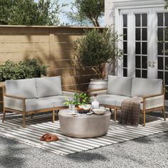 an outdoor patio with furniture and potted plants