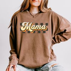 Mama Groovy: 70s Vibes for the Modern Mama in the Comfort Colors 1466 super trendy sweatshirt now available in new earth tones.  Channel your inner earth goddess with our "Mama Groovy" sweatshirt. This ain't your grandma's mama bear tee (unless your grandma was a total hippie). We're talking retro vibes, bold checkerboard patterns, and a whole lotta love for the coolest mama on the block. This ain't just a sweatshirt. It's a lifestyle. It's a nod to simpler times, when macrame plant hangers and Groovy Sweatshirt, Inner Earth, Trendy Sweatshirts, Groovy 70s, Simpler Times, Whole Lotta Love, 70s Vibes, Earth Goddess, Sweatshirt Trendy