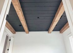 an empty room with wood beams on the ceiling