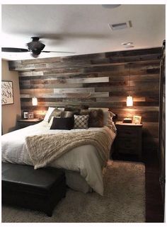 a bedroom with a bed, nightstands and ceiling fan in the middle of it