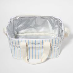 a blue and white striped tote bag on a white background with the lid open