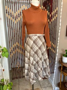 Classic 70's wool blend plaid midi. This skirt is too small for the dress form which is a modern size 8. I would say this is a solid size 6, or large 4. But please check the measurements below. The waistband has no stretch. Zip and button closure. There was one small repair in the back, very tiny, see photo. Cute little top stitched pleating detail throughout. A-line shape. Measurements are: Waist 25 inches  Hips 41 inches  Length 28 1/2 inches Vintage Fall Pleated Skirt, Vintage Pleated Skirt For Fall, Vintage Full Pleated Skirt For Fall, Fall Fitted Full Pleated Skirt, Fitted Brown Pleated Skirt For Fall, Fitted Pleated Skirt For Fall, Fitted Full Pleated Skirt For Fall, Vintage A-line Skirt For Fall, Retro Knee-length Fall Skirt