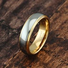 two tone gold and silver wedding ring on wood