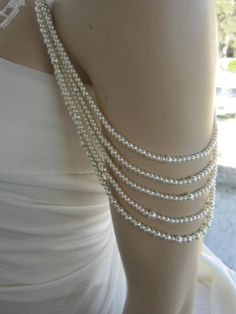 Shoulder Necklace Bridal shoulder necklace 2 pieces per order. 4 handcrafted pearl and brooch Shoulder Necklace Bridal shoulder necklace 2 pieces per order handcrafted beaded made to order Please get in touch for more information. Thank you so much for choosing my store. It is very importent to let my customers happy, so dont hesitate to contact me for your questions. Standart shipping I ship from Turkey , General delivery durations are USA : 12 /20 days Canada : 10/20days Australia: 15/25 days Off The Shoulder Dress Jewelry Necklaces, Elegant White Pearl Chain Body Jewelry, Elegant White Body Jewelry With Pearl Chain, Elegant White Body Jewelry For Evening, Elegant Beaded Pearl Body Jewelry, Delicate Beaded Pearl Necklace For Wedding, Elegant Pearl White Wedding Backdrop Necklace, Elegant Pearl White Backdrop Necklace For Wedding, Elegant Body Jewelry For Formal Occasions