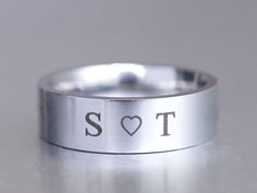 Initial Heart Ring, Custom Engraved Ring, Personalized Couple Ring, Stamped Ring, Stainless Steel Ring, Anniversary Gift for Her or Him Your own one-of-a-kind ring for men or women, features the two initials and a sweet heart on this stainless steel ring. This is a great everyday ring, and has a nice polished look for mixing with other accessories. You still can say it your own sayings on the ring. As you check out, please indicate your special request in the Note to Seller box. Still available to engrave other choices like loved one's names, baby names...or anything else close to your heart. I T E M ∙ D E T A I L S Shiny polished Silver ( stainless steel, a high quality metal that does not tarnish and is hypoallergenic. ) 6 mm band wide The listing is for one ring. Still available for the Personalized Engraved Silver Ring For Valentine's Day, Customizable Silver Engraved Ring For Valentine's Day, Silver Rings With Initials For Valentine's Day, Silver Valentine's Day Ring With Initials, Valentine's Day Silver Ring With Initials, Customizable Silver Heart Promise Ring, Silver Engraved Ring For Valentine's Day Promise, Personalized Silver Heart Ring For Wedding, Silver Engraved Heart Ring For Wedding