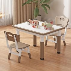 a white table with two chairs and a potted plant