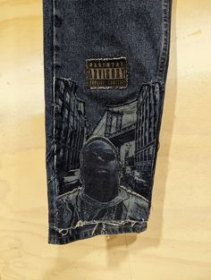 Customized Denim Jeans ( B.I.G Brooklynn Tribute) - Triple Applique Patchwork - Laser Engraving Finish - Stonewash 100% Cotton Relaxed Fit 33W x 32L Urban Fitted Jeans For Streetwear, Grunge Graphic Print Jeans For Streetwear, Fitted Urban Jeans For Streetwear, Urban Style Jeans For Streetwear, Denim Blue Graphic Bottoms For Streetwear, Dark Wash Recycled Denim Jeans For Streetwear, Urban Jeans With Graphic Print On Denim, Urban Jeans With Graphic Print, Urban Graphic Print Denim Jeans