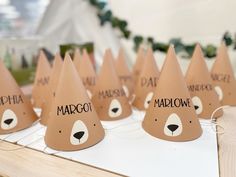 there are many brown paper hats that say margot and have bears on them