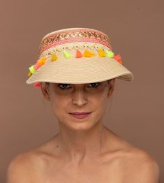 Experience the perfect blend of sophistication and effortless style with our beautifully handcrafted synthetic straw capeline sun visor, adorned with a vibrant boho theme tassle band that effortlessly complements any ensemble with a subtle, yet striking accent. Handcrafted from durable, water-resistant straw, this lightweight hat embodies travel-friendly luxury, easily stowable in your suitcase for spontaneous getaways. Whether lounging at the beach, elevating your casual day look, or adding a touch of sophistication to your summer gatherings, this visor is your ultimate everyday accessory. Sweatband is included as in the picture.  From smart resort wear to relaxed denim, swimwear to flowing summer dresses, and even chic kaftans, our versatile hat seamlessly integrates into any wardrobe. P Luxury Casual Sun Hat For Outdoor, Luxury Casual Sun Hat For Outdoors, Luxury Summer Hats For Everyday Wear, Luxury Casual Sun Hat For Summer, Luxury Bohemian Sun Hat For Women, Luxury Bohemian Sun Hat For Vacation, Luxury Casual Beach Hats, Luxury Casual Sun Hat, Luxury Chic Straw Sun Hat