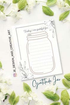 a card with a jar on it surrounded by white flowers and green leafy leaves