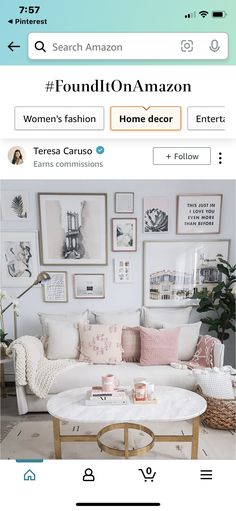 a living room with pictures on the wall and a coffee table in front of it