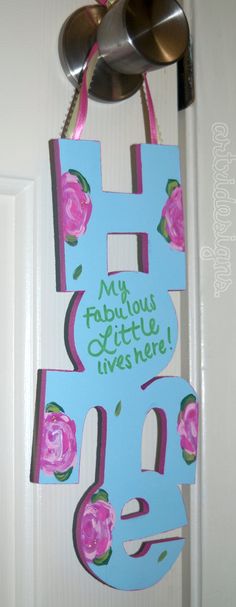 a door hanger with the letter h painted on it