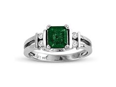 Emerald and Diamond Ring in 14k White Gold. The diamonds have a total carat weight of 0.10 carats. Emerald Ring With Center Stone In 14k White Gold, Anniversary Emerald Ring With Brilliant Cut In Platinum, Anniversary Platinum Emerald Ring With Brilliant Cut, Classic Emerald Solitaire Rings, Platinum Emerald Ring For Anniversary, Hallmarked Platinum Emerald Ring For Formal Occasions, Classic Emerald Ring With Prong Setting For Promise, Classic Emerald Ring With Prong Setting As Promise Ring, Classic Emerald Promise Ring With Prong Setting