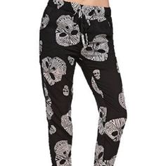 The Lira Skull Head Pants In Black These Relaxed Drawstring Pants Feature A Sugar Skull Graphic Throughout. Wear These Pants With Your Favorite Crop Top And Sneakers And Hit The Town In This Morbid Style. Drawstring Pants Sugar Skull Graphic Throughout Front Pockets 38.5" From Waist To Cuff Machine Wash Self: 100% Polyester, Lining: 100% Polyester Imported Price Drop. Firm Fuzzy Skull Pants, Skull Graphic, Skull Head, Drawstring Pants, Price Drop, Favorite Person, Sugar Skull, Pant Jumpsuit, Straight Leg