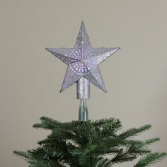 a silver star on top of a christmas tree