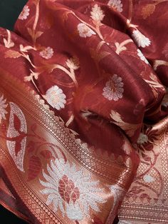 Gorgeous Semi Banarasi Silk Saree in Brick Red color with Copper and Sliver Zari. Floral Jaal Design on the body of the Saree with Grand Pallu. Item : SareeBase Fabric : Semi Banarasi SilkColor : Brick Red Blouse piece : Comes with un-stitched Blouse piece.Blouse material : Semi Banarasi SilkFall & Edging(Yes/No) : Yes Disclaimer -:- Color variation is possible due to various reasons like phone or desktop setting, resolution etc. Please don't hold us responsible. Our aim is to put the exact colo Silver Anarkali For Festivals, Silver Anarkali Traditional Wear For Festivals, Elegant Red Handloom Traditional Wear, Silver Art Silk Dupatta For Festivals, Red Bollywood Style Handloom Lehenga, Silver Handloom Dupatta For Festive Occasions, Silver Dupatta For Navratri Festivities, Red Anarkali Set With Self Design For Celebration, Red Self Design Anarkali Set For Celebration