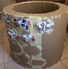 a cardboard box that has some stickers on it and is sitting on the floor