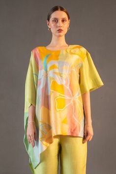 Lime asymmetric kaftan with abstract geometric and floral print. Paired with striped straight pant. - Aza Fashions Spring Tunic Sets With Printed Motifs, Spring Silk Tunic Set, Spring Printed Tunic Sets, Spring Asymmetrical Sets, Chic Sets With Asymmetrical Hem For Spring, Multicolor Summer Tunic Sets, Spring Yellow Tops With Printed Motifs, Printed Tunic Sets For Summer, Summer Printed Tunic Sets