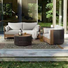 an outdoor living room with couches and tables