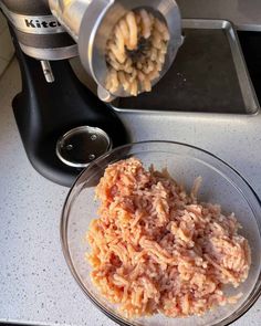 a bowl filled with food next to a blender