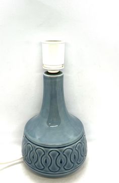 a blue vase with a light on top of it