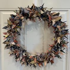 an origami wreath hanging on the front door