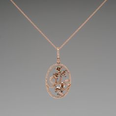 This gorgeous Carlo Viani necklace is crafted of 14k rose gold and features a floral diamond motif. The pendant is set with 6 fancy brown pear cut diamonds, 2 fancy brown round brilliant diamonds, and 94 smaller round brilliant accent diamonds. The total diamond weight is 1.89 carats. The pendant is in excellent condition and hangs from a 14k rose gold 18-inch chain. Ask us about a matching Carlo Viani ring. Luxury Oval Diamond Necklace With Rose Cut, Luxury Brown Jewelry With Diamond Accents, Luxury Brown Jewelry With Brilliant Cut, Brown Diamond Jewelry For Formal Occasions, Elegant Oval Brown Jewelry, Formal Brown Diamond Jewelry, Elegant Brown Oval Jewelry, Luxury Diamond Necklace With Rose Cut Flower Pendant, Luxury Rose Cut Diamond Flower Pendant Necklace