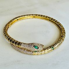 Indulge in luxury with our Sedona Snake Bracelets. Made with top quality 18kg gold filled, these emerald studded cuffs exude sophistication and won't tarnish. Affordable and beautiful, elevate your style with a touch of serpentine elegance. Luxury Snake Shape Bracelets For Women, Green Luxury Bangle Jewelry, Luxury Emerald Bangle Jewelry, Elegant Gold Bangle With Emerald, Luxury Flexible Gold Plated Jewelry, Luxury Flexible Gold-plated Jewelry, Formal Emerald Bangle Jewelry, Gold Emerald Bracelets For Formal Occasions, Formal Gold Bracelets With Emerald