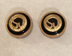 Vintage St. John Gold Plated Black Enamel Round Signature Clip On Earrings -vintage 1980's -24 grams in weight -22k Gold plate -black enamel -round clip on -St. John signature logo enveloped in black enamel with gold edging  -St. John makers mark on earring backs -1.25 in. Diameter -Very good used condition -Review pics and video for additional details -Thank you for looking! Vintage Gold Enamel Clip-on Earrings, Formal Gold Clip-on Earrings With Black Enamel, Vintage Black Enamel Clip-on Earrings, Vintage Gold Clip-on Earrings With Black Enamel, Vintage Black Round Clip-on Earrings, Black Vintage Round Clip-on Earrings, Vintage Black Enamel Earrings, Vintage Round Enamel Earrings, Earrings Vintage