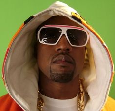 a man wearing sunglasses and a hoodie over his head is looking at the camera